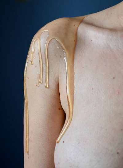 Close-up of woman covered in honey