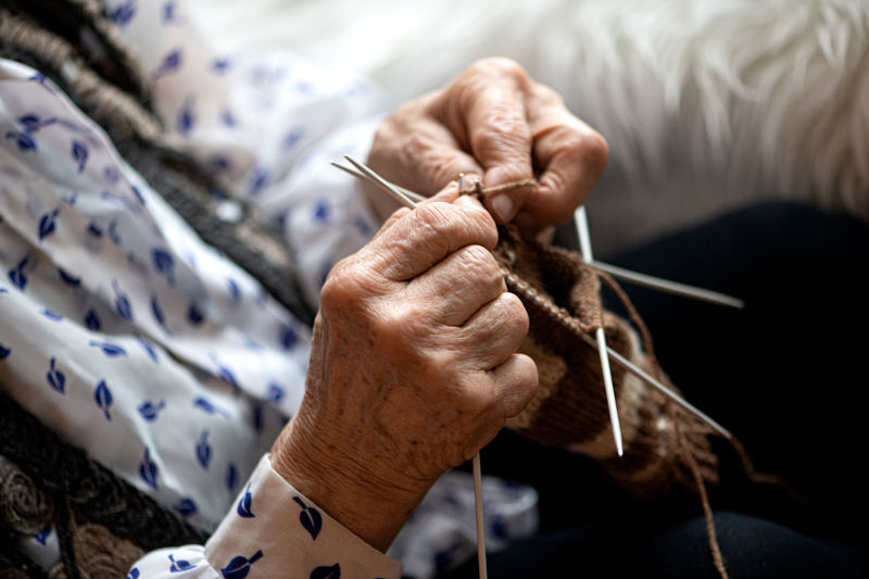 Midsection of senior woman crocheting