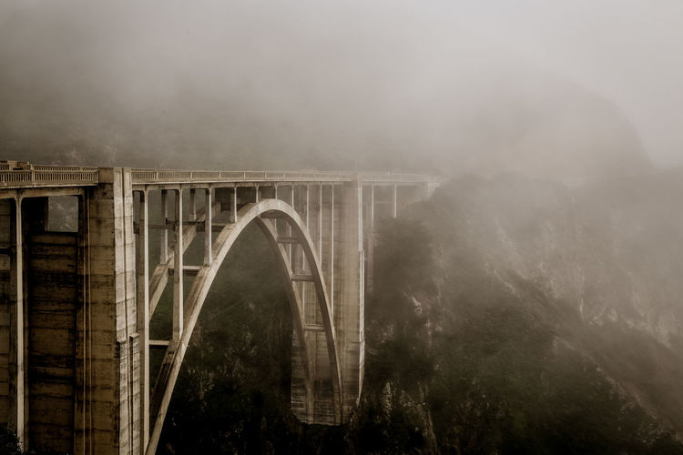 Arch bridge during foggy weather