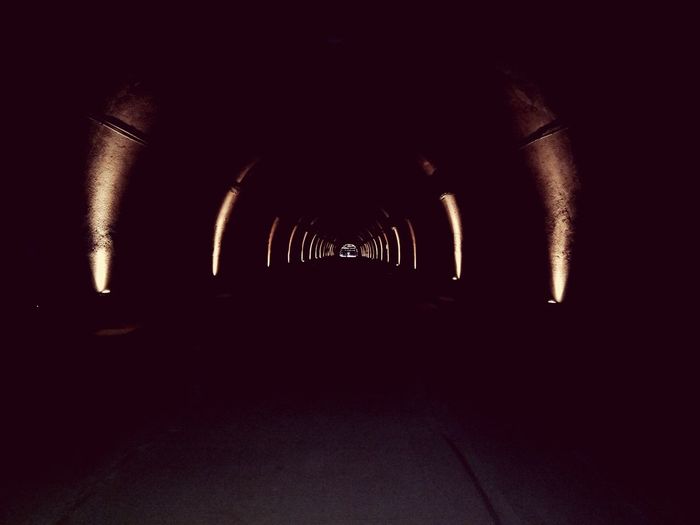 Silhouette of illuminated tunnel