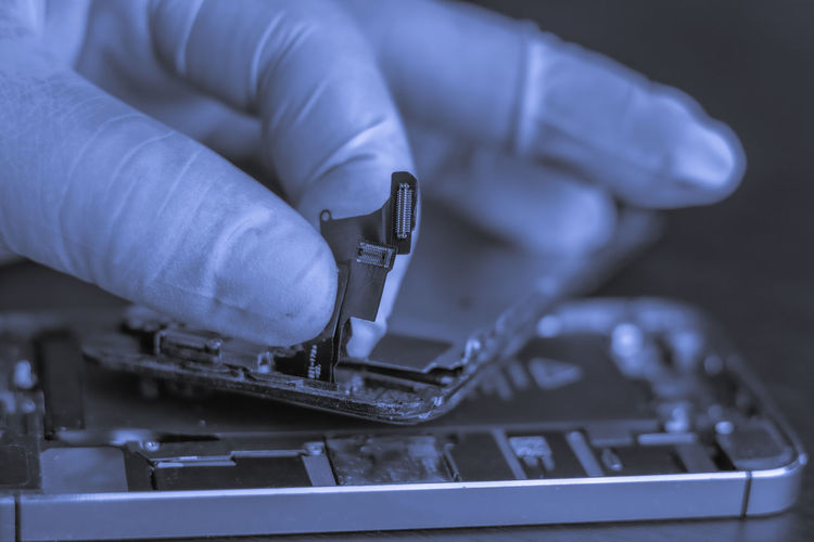 Cropped hand of person working on computer equipment