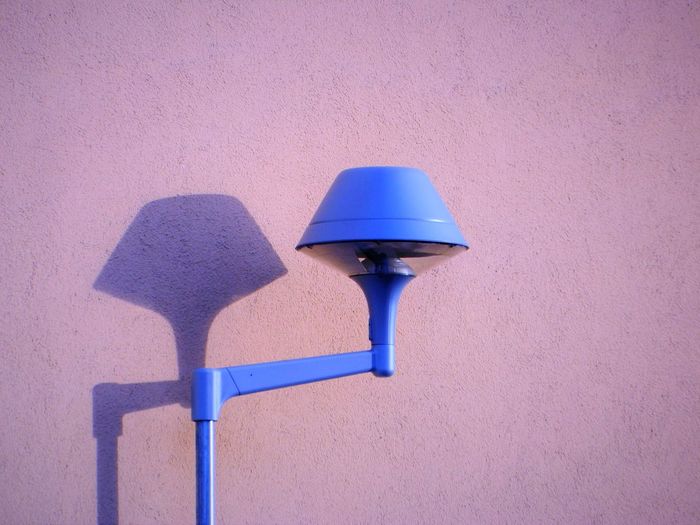 Close-up view of lamp against wall