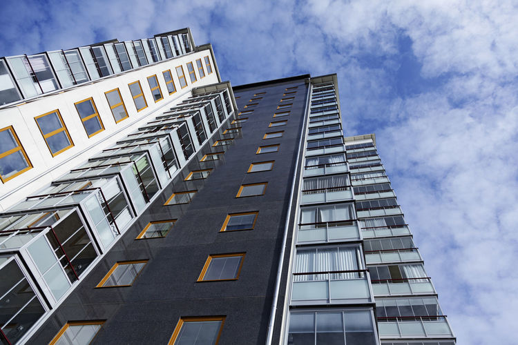 New modern high-rise building on sandakern with a blue cloudy summer sky