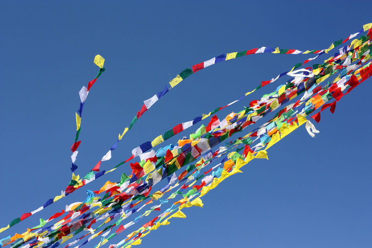 Low angle view of prayer flags against clear sky