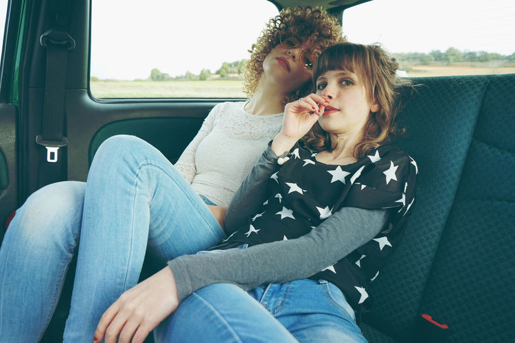 Female friends sitting in car