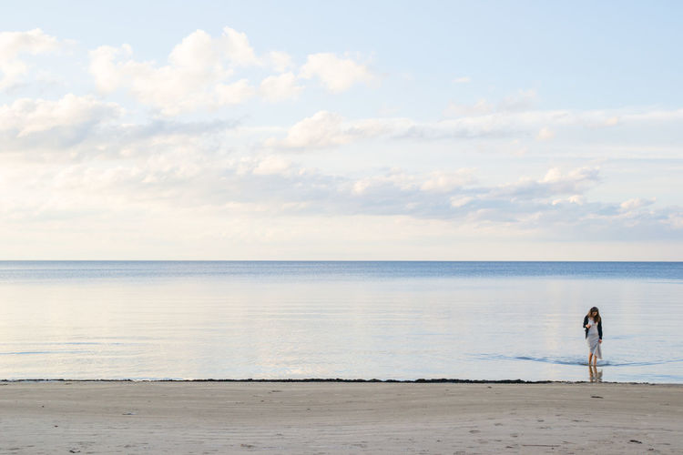 Woman walking in shallow water on a beach