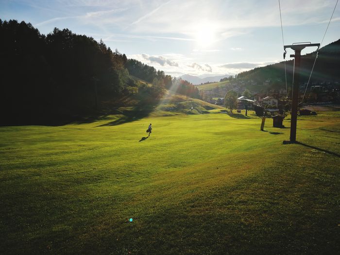 Scenic view of golf course against sky