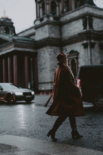 Woman with umbrella walking on street in rain