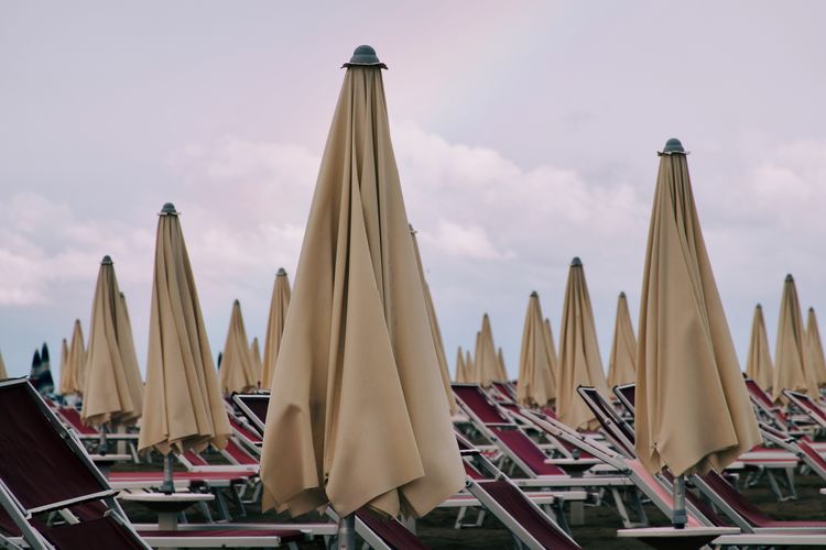 Low angle view of beach umbrellas against sky