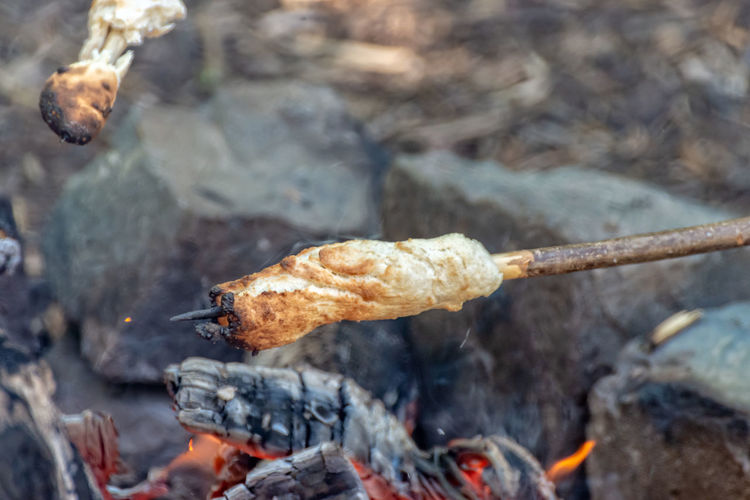 Close-up of food roasting over campfire