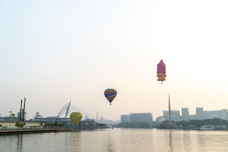 View of hot air balloon flying over river