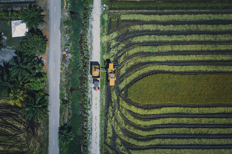 Directly above view of combine harvester on field
