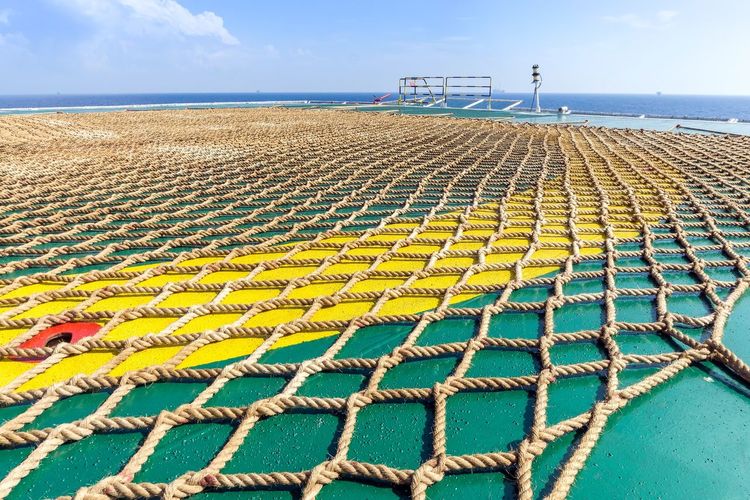 Helideck netting laid on the helipad of a construction work barge at offshore oil field