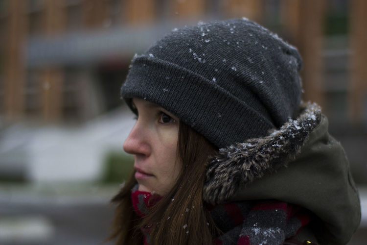 Close-up of woman looking away during winter