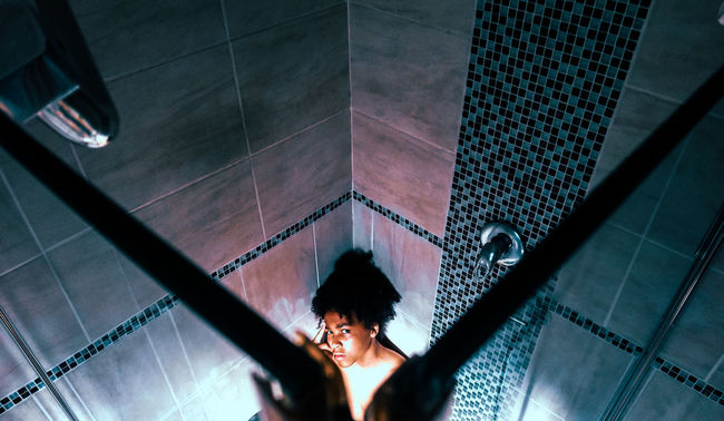 High angle view of teenage boy in bathroom