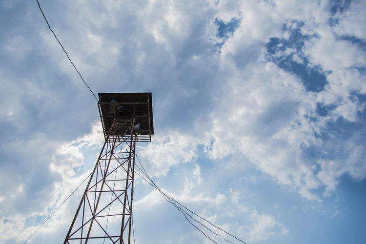 Low angle view of lookout tower against cloudy sky