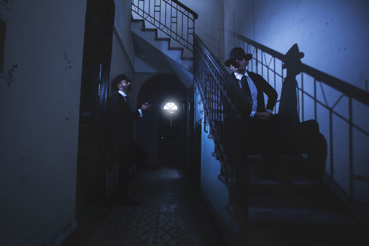 Man standing on staircase at night
