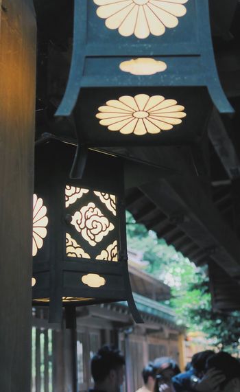 Close-up of illuminated lantern hanging in temple