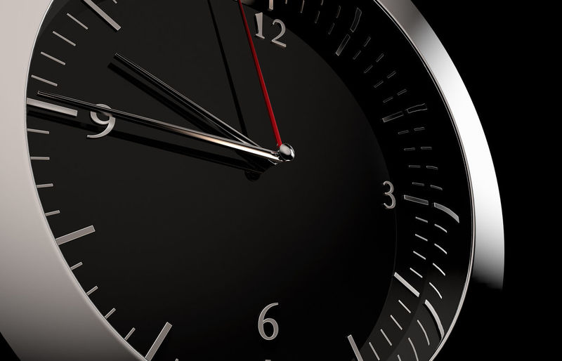 Close-up of clock against black background