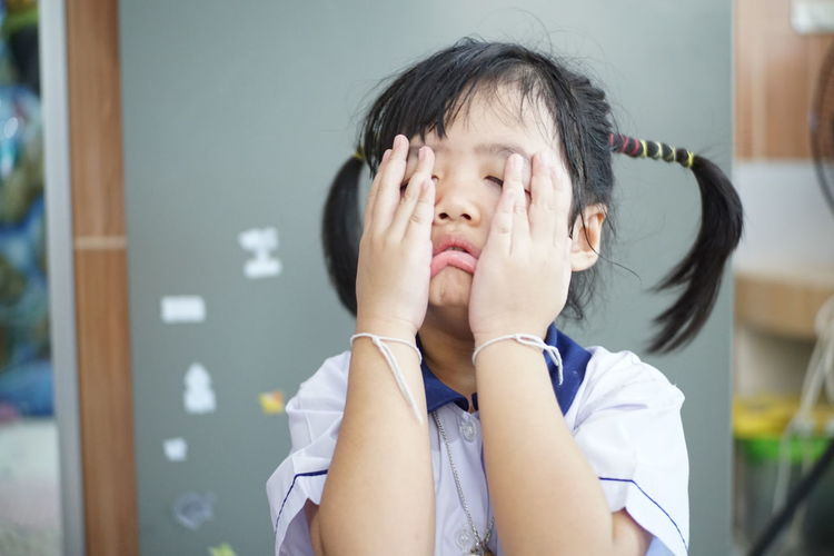 Close-up of girl crying in classroom