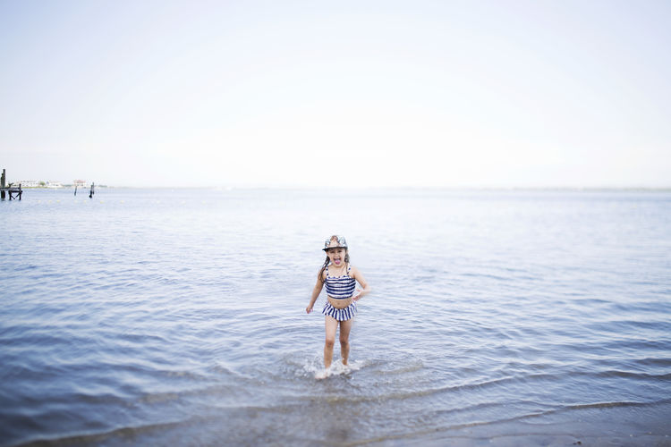 View of girl playing in sea