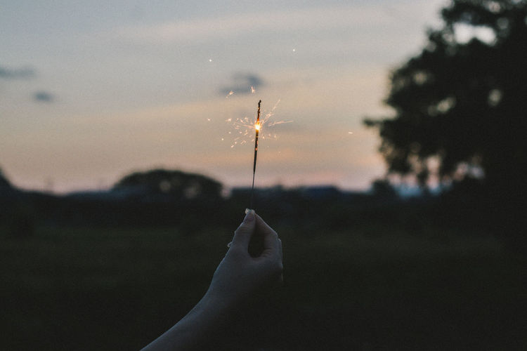 Close-up of person holding sparkler