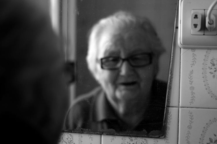 Reflection of senior woman in mirror