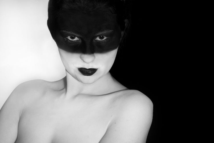 Portrait of young shirtless woman wearing eye mask