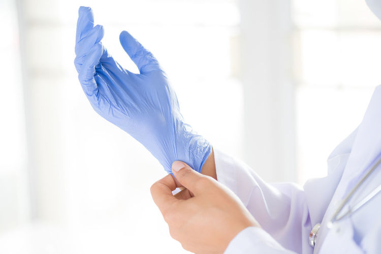 Close-up of doctor wearing glove
