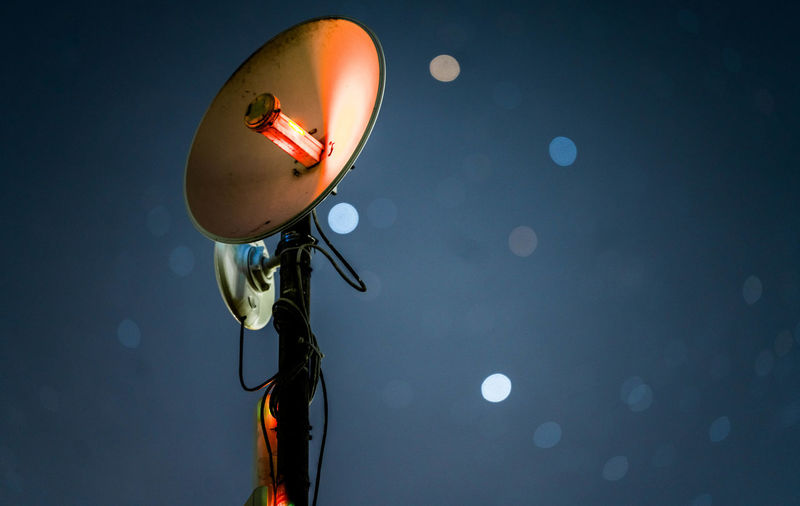 Low angle view of satellite dish against sky at night
