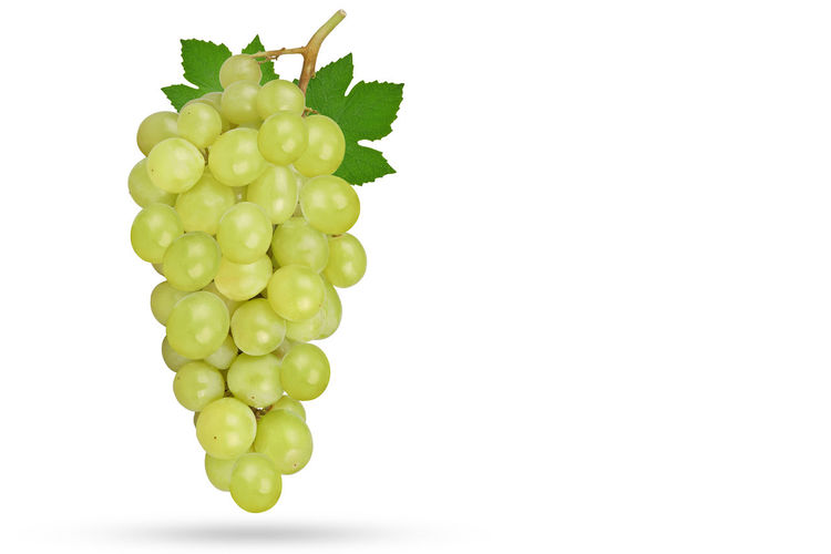Close-up of grapes over white background