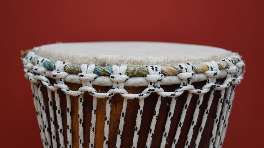 Close-up of djembe against red background