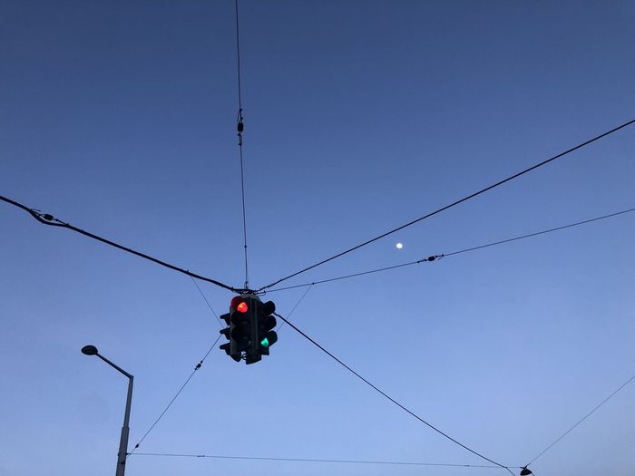 Low angle view of traffic light against clear sky