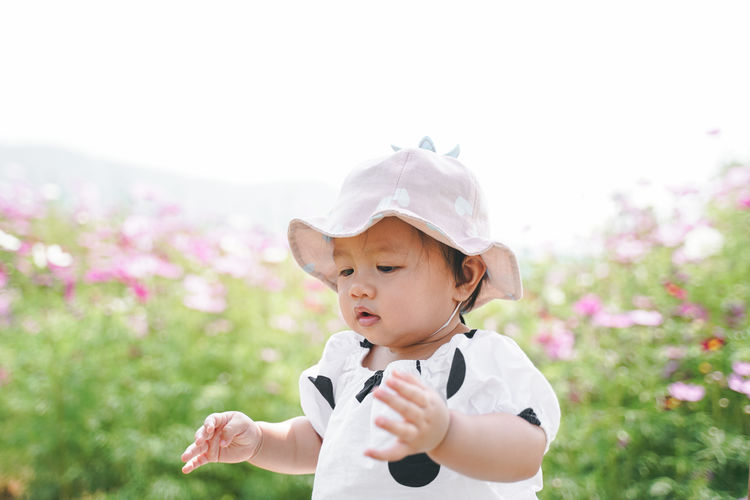 Cut girl wearing hat against sky