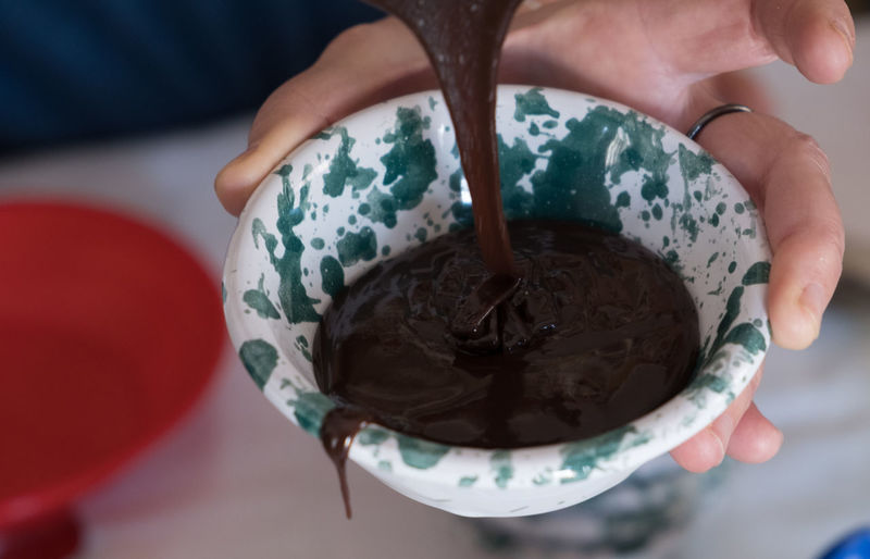 Cropped hand of person pouring water