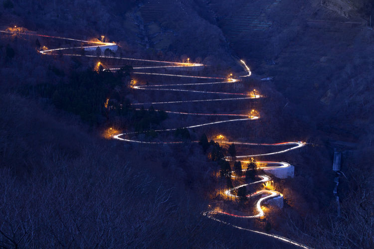 Illuminated winding road at night