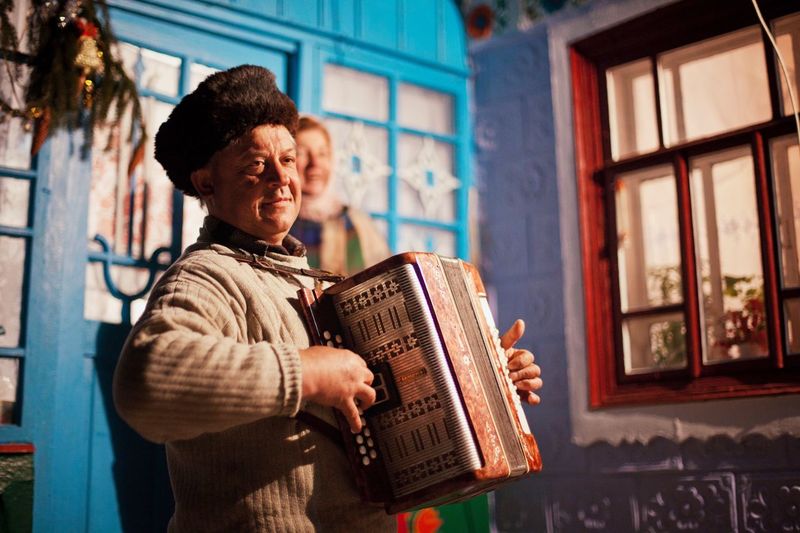 Mature street musician playing accordion