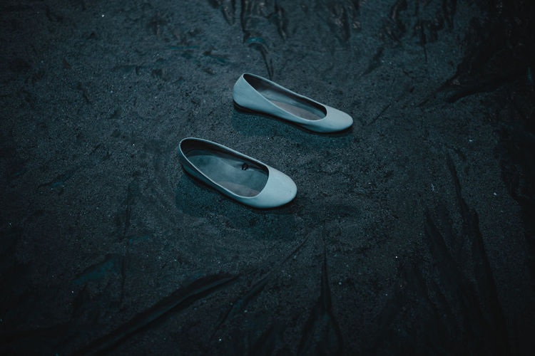 Shoes on grey sand