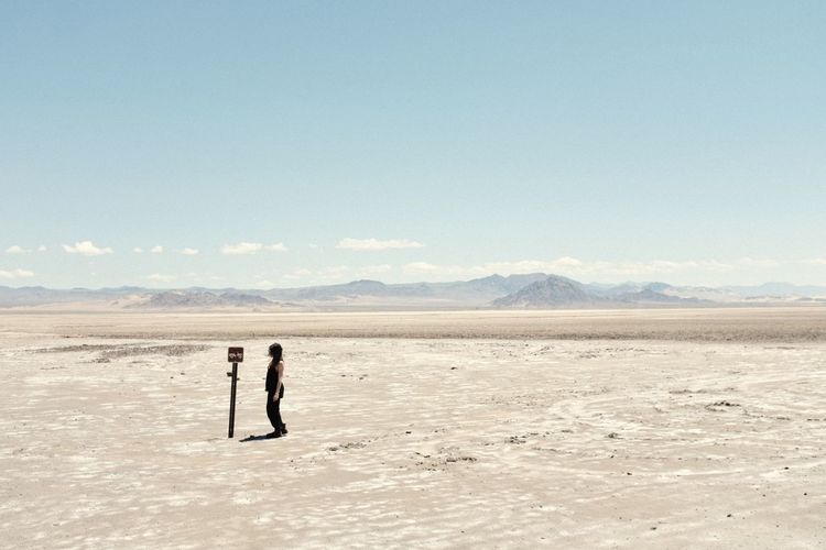 Men standing on desert against sky