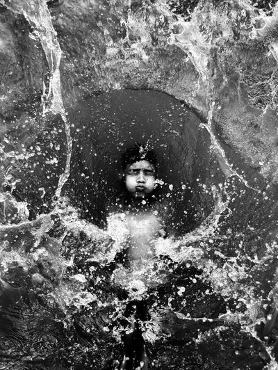 High angle view of boy swimming in river