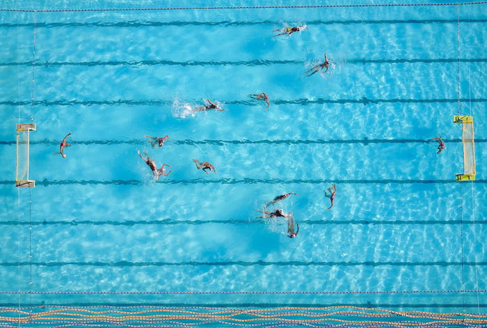Directly above shot of people swimming in pool