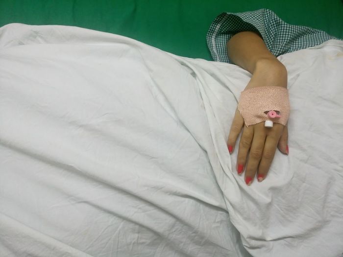 Midsection of woman with iv drip at hospital