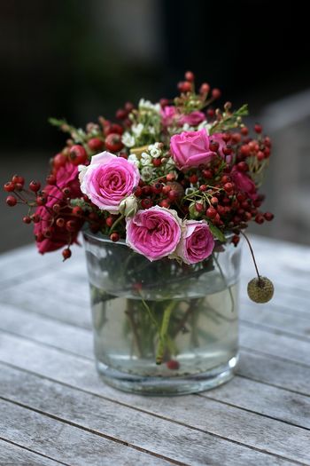 Close-up of pink roses in vase on table