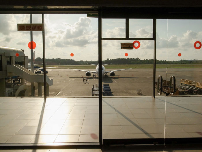 Airport runway seen through airplane window