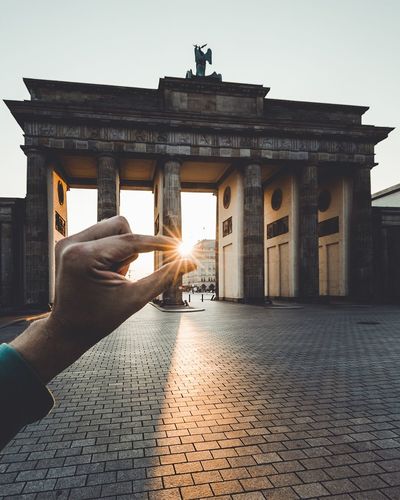 Close-up of hand pretending to hold the sun