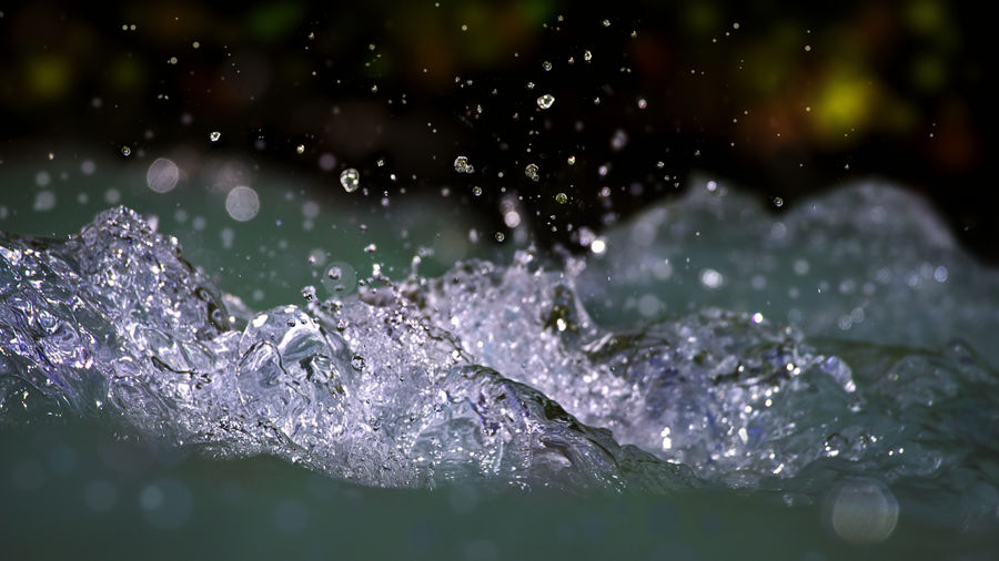 Close-up of water splashing against blurred background