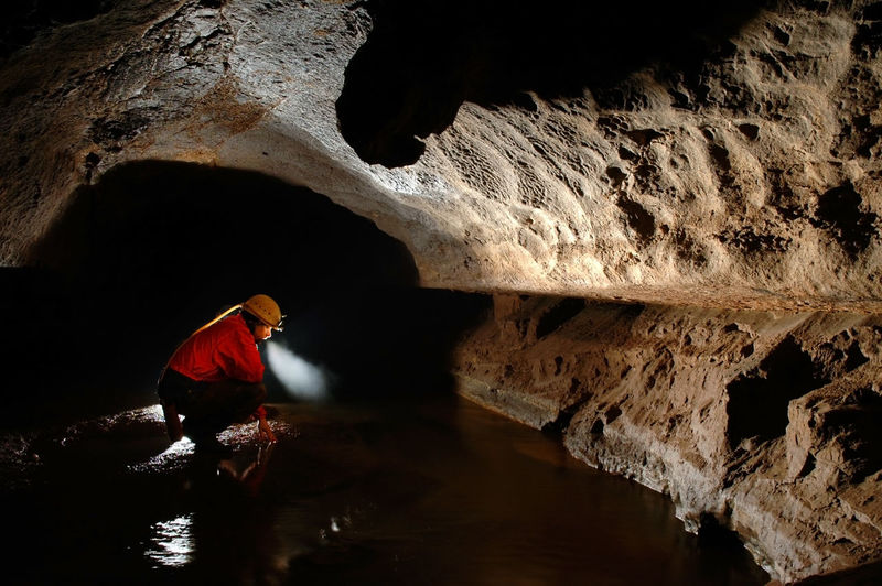 Side view of spelunker in cave