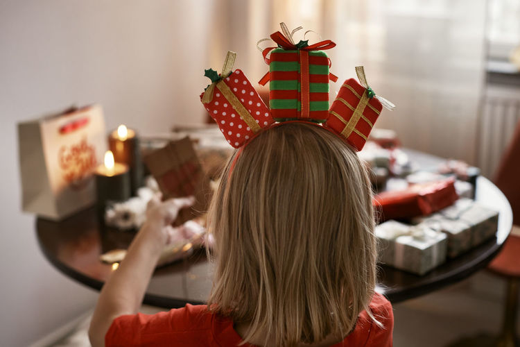 Rear view of woman holding christmas decoration