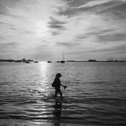 Silhouette of woman in sea