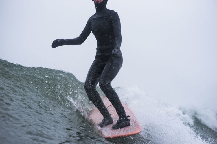 Woman surfing during winter snow